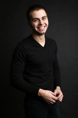 Handsome young man on dark background