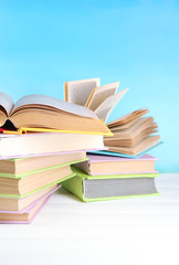 Stacks of books on table on natural background