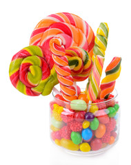 Different colorful fruit candy in jar isolated on white