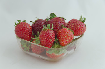 Strawberries with leaves on the bowl
