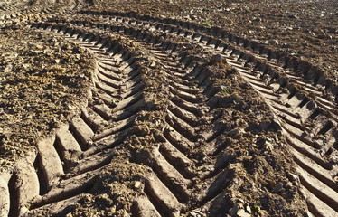 Track of a tractor on a plowed field