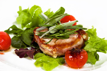 gourmet pork with rolled bacon, tomatoes, salad and herbs
