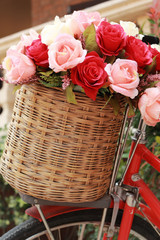 Fototapeta na wymiar beautiful of rose artificial flowers in vintage bicycle