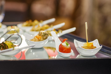 Different tasty snacks on luxury banquet table