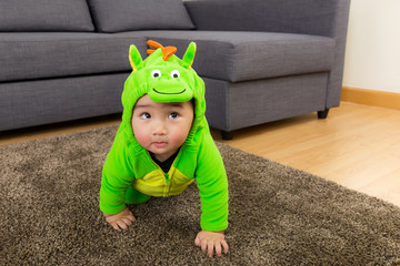 Young baby boy dressed in dinosaur
