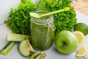 Fresh organic green smoothie with salad, apple, cucumber, pineap