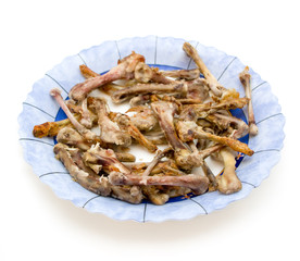 Chiken wings bones on a plate isolated on white background