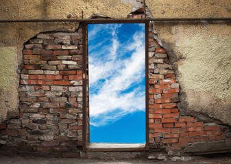 Empty doorway with sky in old weathered brick wall