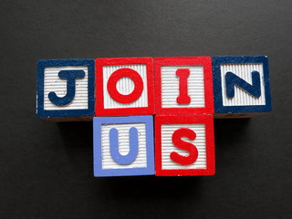 alphabetical blocks with the message of "Join Us"