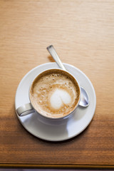 Coffee cup with milk on the table