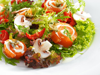 Fresh delicious salmon rolls with cream cheese on lettuce with b