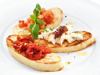 Assorted bruschetta with salmon, air-dry tomatoes or goat cheese