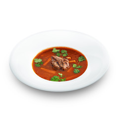 Hot delicious tomato soup with meat and rice served with leek an