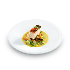 Fish an vegetables on plate isolated on white