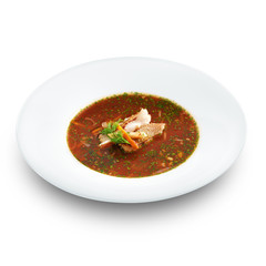 Hot delicious tomato soup with fish and rice served with leek an