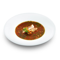 Hot delicious tomato soup with fish and rice served with leek an