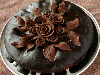 homemade glazed cake decorated with chocolate roses