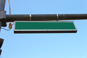 Green road sign on a city street