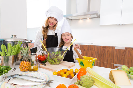 Kid Girls Junior Chef Friends Hug Together In Countertop