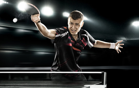sports man tennis-player on black background