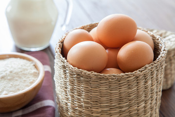 Eggs, milk and flour on a wooden table