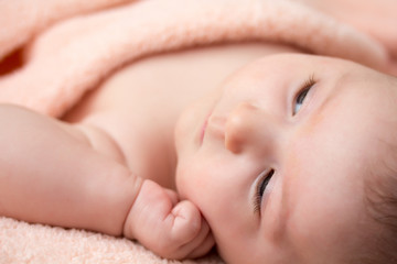 Bright portrait of adorable thinking newborn baby girl