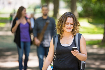 Female Student Using Cellphone On Campus