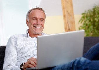 Fototapeta premium Mature man with laptop at home