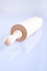 A wooden rolling pin on the white background