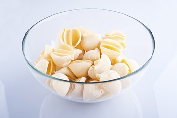 Conchiglie pasta on white background