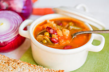 Minestrone soup on wooden background