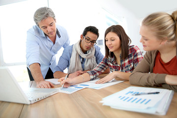 Business school students in marketing class with teacher