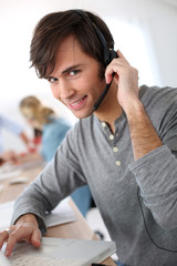 Student with headset on doing English language test