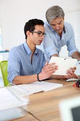 Young man in business training school with teacher