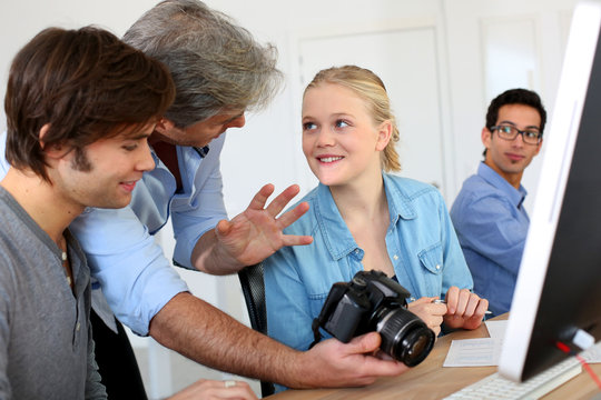 Teacher in class of photography with students