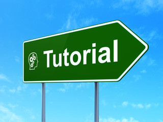Education concept: Tutorial and Head With Gears on road sign