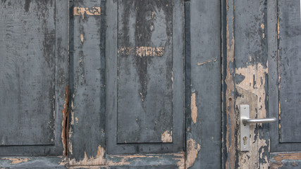 Weathered grey paint on an old door