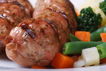 Hot grilled sausage garnished with vegetables