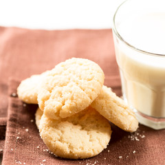 Cookies and milk in glass on napkin square
