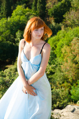 Fototapeta na wymiar red-haired girl in a blue dress
