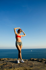 slim girl on the background of sky