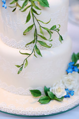 Fototapeta na wymiar White wedding cake decorated with flowers