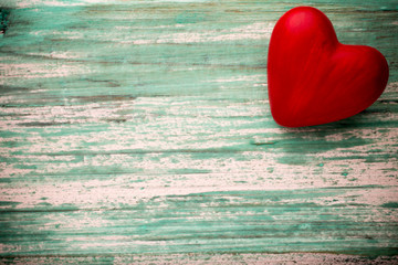 Fototapeta premium Heart on a wooden background. Vintage style.