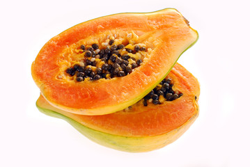 two halves of fresh papaya isolated on white