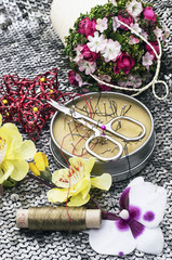 composition with sewing tools and floral decorations