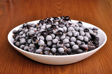 heap of frozen black currant in a plate