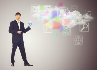 Businessman with tablet and the cloud with applications icons