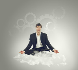 Businessman sitting in lotus position on a cloud