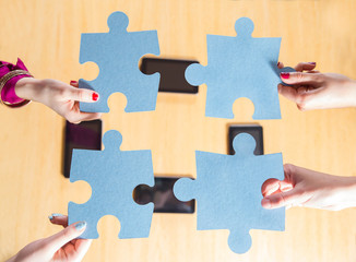 Group of business people assembling  puzzle, team work