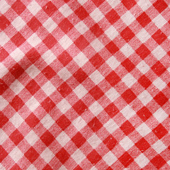Texture of a red and white checkered picnic blanket.